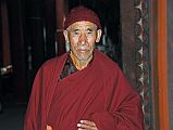Lo Manthang Thubchen 05-1 Entrance Monk A monk was leaving the assembly hall of the Thubchen Gompa in Lo Manthang during a break from morning prayers, and asked me to take his photo.